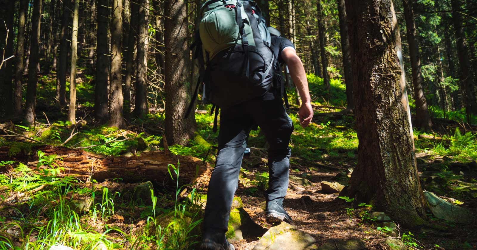 Hiker hunched over due to heavy pack